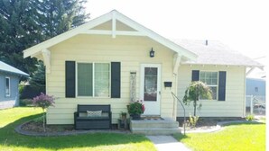 A single-story house with a front porch, a bench, and a small garden area. - Clean and cozy 3 bdrm one bath home in the heart of Rupert.  (Rupert)