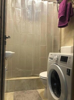 Shower, hair dryer, slippers, towels