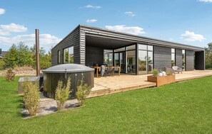 A modern house with a patio, a barbecue, and a large window. - Cozy home in Tarm with WiFi (Tarm)