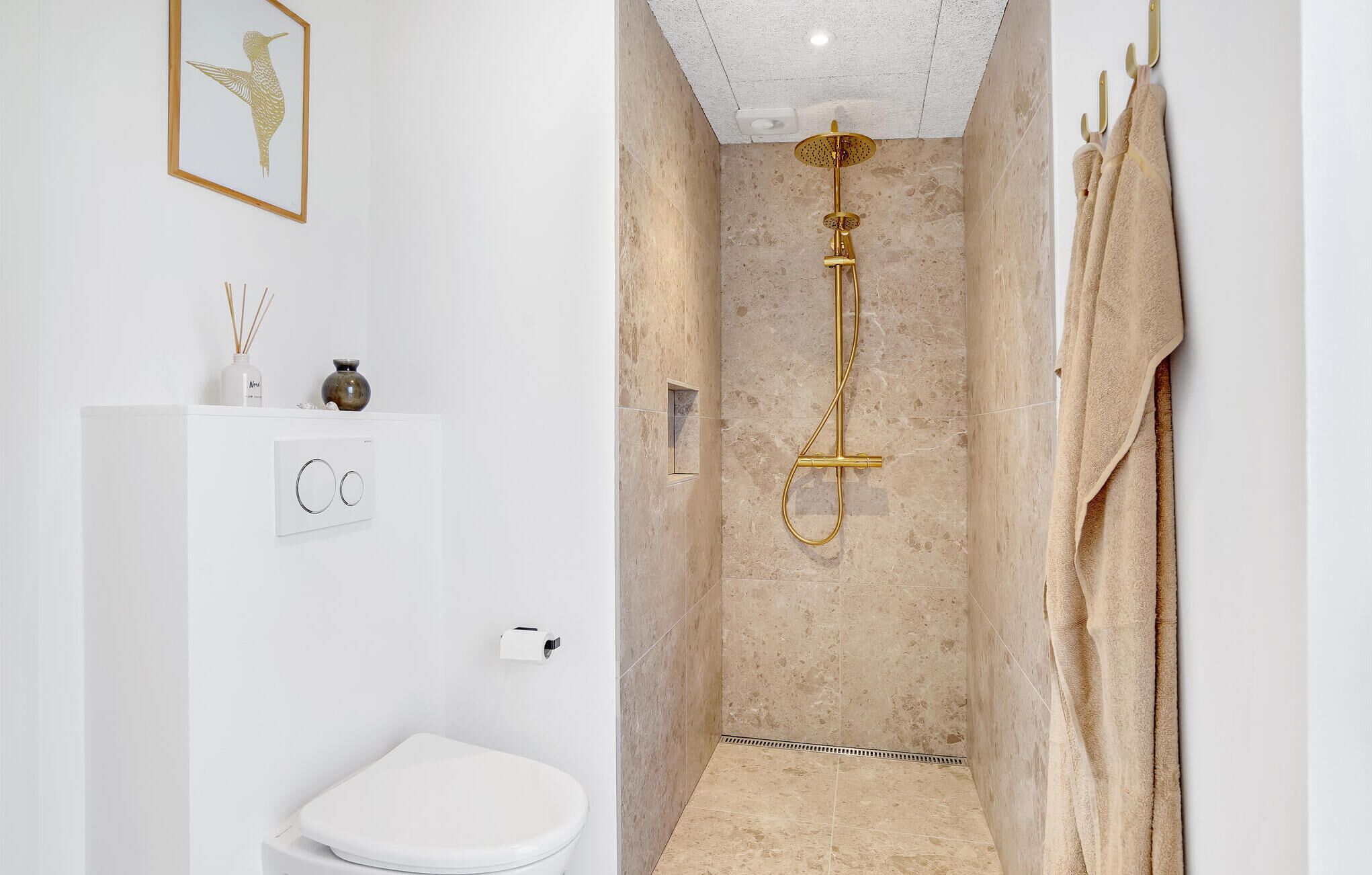A bathroom with a shower, toilet, and sink.