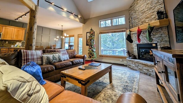 A spacious living room with a fireplace, a large window, and a cozy seating area. - Starfire 1994 (Keystone)