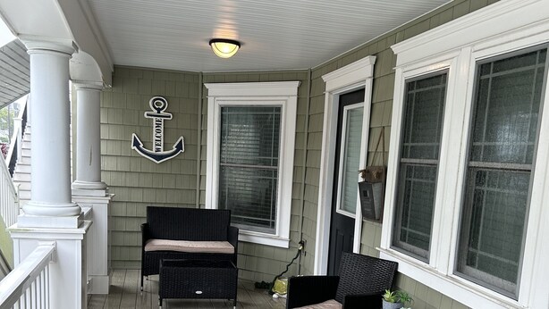 A covered porch with wicker furniture, a welcome anchor sign, and a ceiling light. - CENTER OF OCEAN CITY - Walk to Beach/Boards/Downtown (Ocean City)