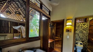 A bathroom with a wooden vanity, a sink, and a toilet. - Hotel Gallo de Mar (Puerto Escondido)
