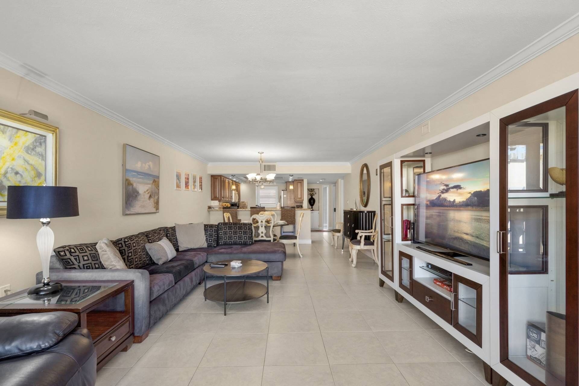 A living room with a sofa, coffee table, and TV stand.