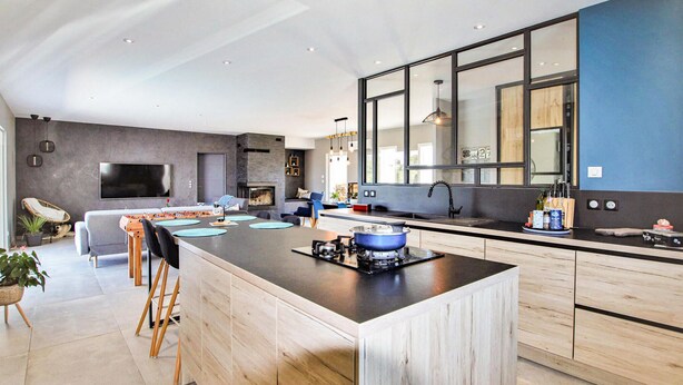 A modern kitchen with a central island, a built-in stove, and a large window. - Nice home in pont-évêque (Pont-Évêque)