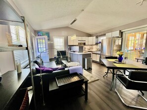 A modern apartment with a living room, kitchen, and dining area. - Artful Cottage Mtn. Retreat - 55 or over (Waynesville)