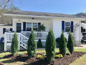 A white house with blue shutters, a front porch, and a small deck. - Artful Cottage Mtn. Retreat - 55 or over (Waynesville)