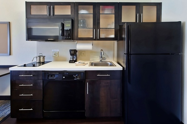 Prepare quick meals with microwave, cooktop, and roomy counters.