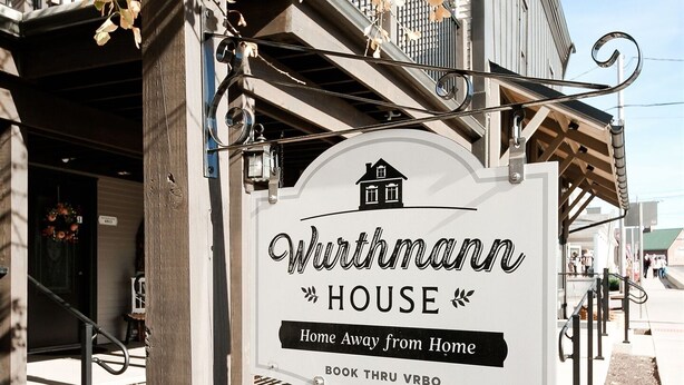 A sign for 'Wirthmann HOUSE' with a house icon, indicating a home away from home. The sign includes a contact number '4813'.