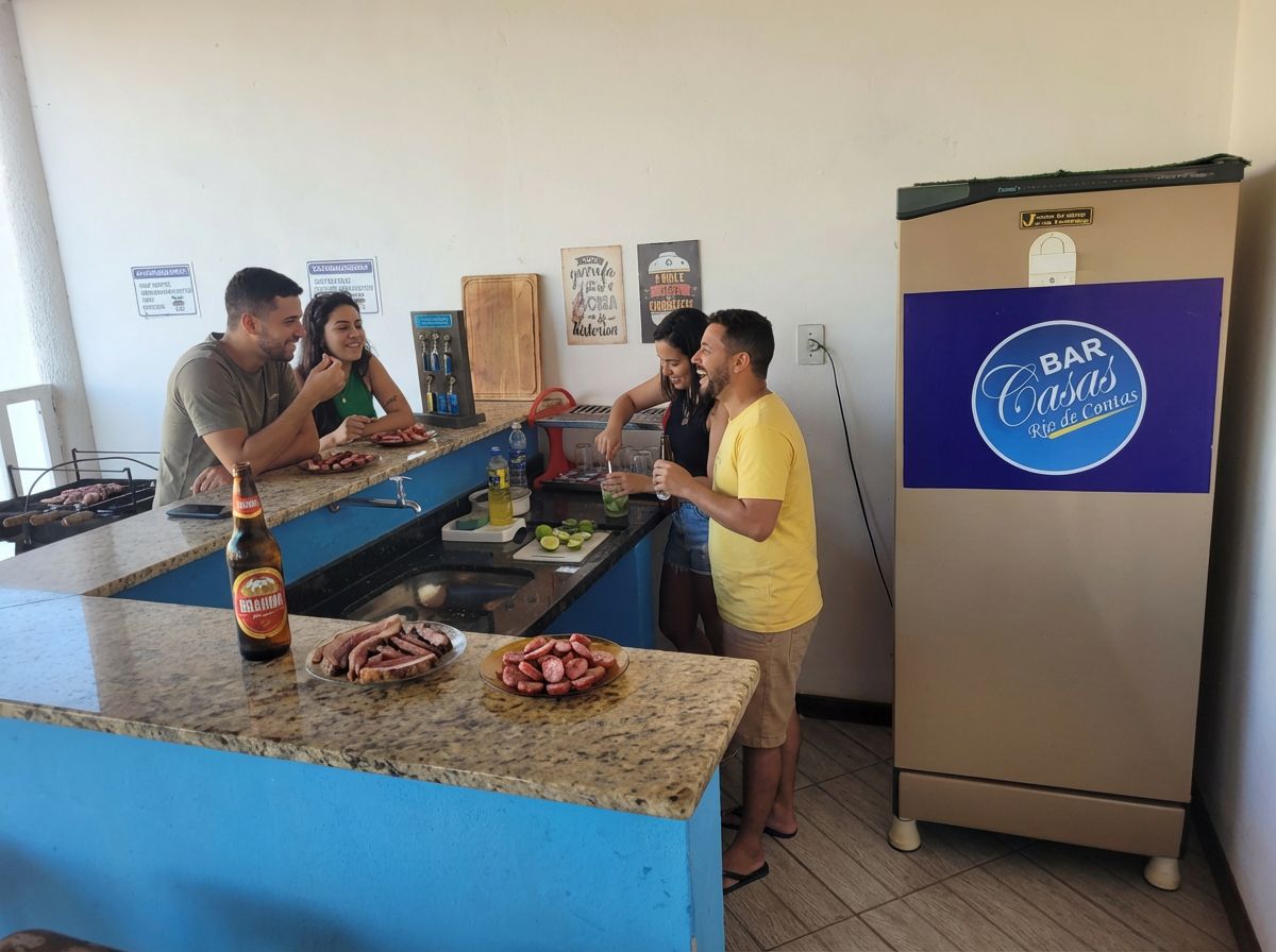 A kitchen area with a bar counter, a refrigerator, and a wall with decorative signs.