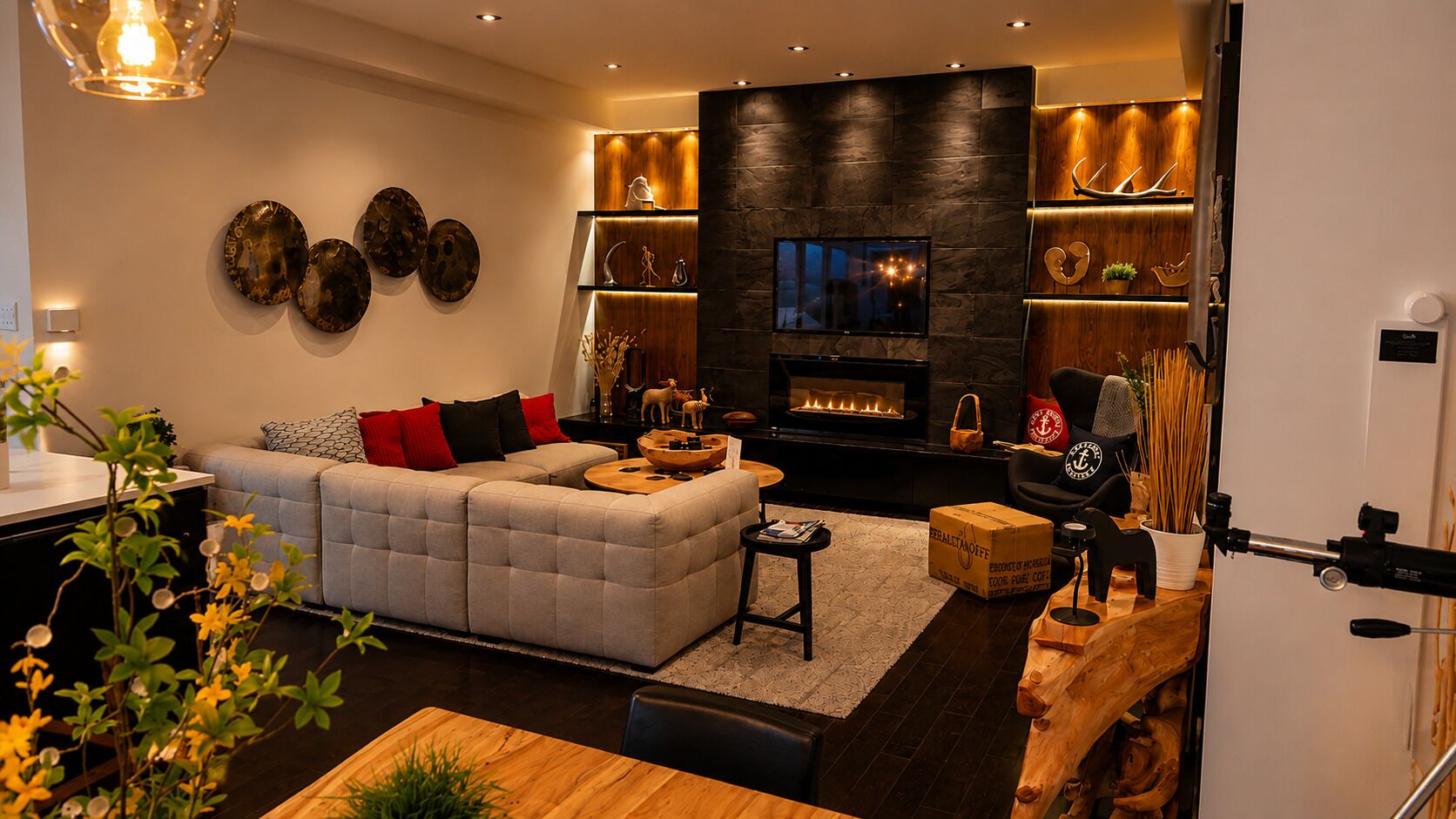 A modern living room with a sectional sofa, a fireplace, and decorative wall art.