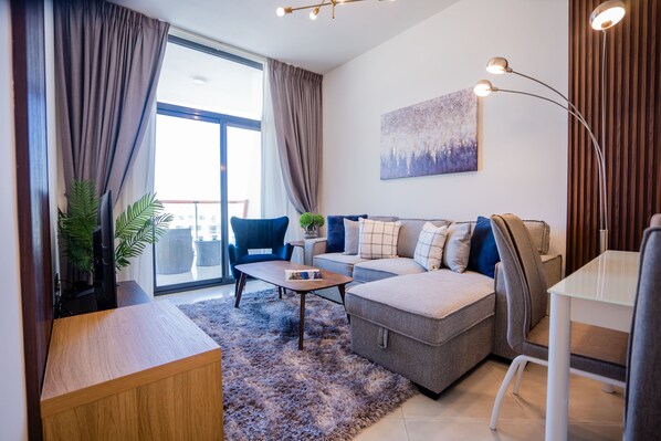 Deluxe Apartment | Living area | 55-inch Smart TV with cable channels, TV