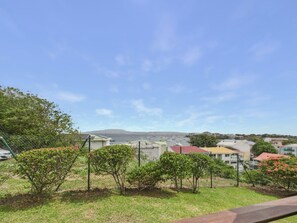 A residential area with houses, a fence, and a clear sky.