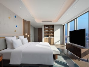 A modern hotel room with a large bed, built-in wardrobe, a TV, and a city view. - Pullman Huai’an (Huai'an)