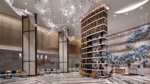 A modern lobby with a central seating area, a reception desk, and a unique ceiling design. - Pullman Huai’an (Huai'an)