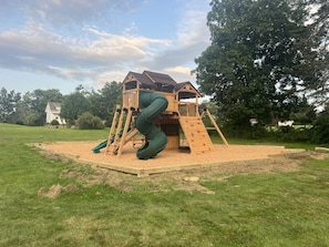 Children can play on the slide, climb the ladder, and relax on the platform with a roof.
