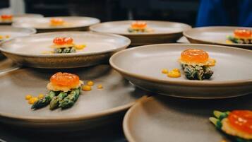 A series of dishes with a central garnish, possibly a type of caviar, on a plate.