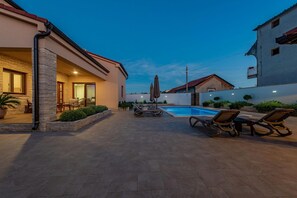 A residential property with a swimming pool, outdoor seating, and a stone facade. - Villa Roza Zadarvillas (Policnik)