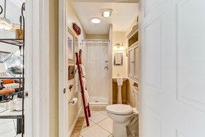 A bathroom with a toilet, shower, and sink. - 534 N. Fletcher Ave. #1 2 Bedroom Cottage by RedAwning (Fernandina Beach)