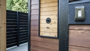 A wooden door with a peephole and a mailbox on the wall. - Sitka Cabin-Modern, Hikes, OD shower, Pet (Ucluelet)