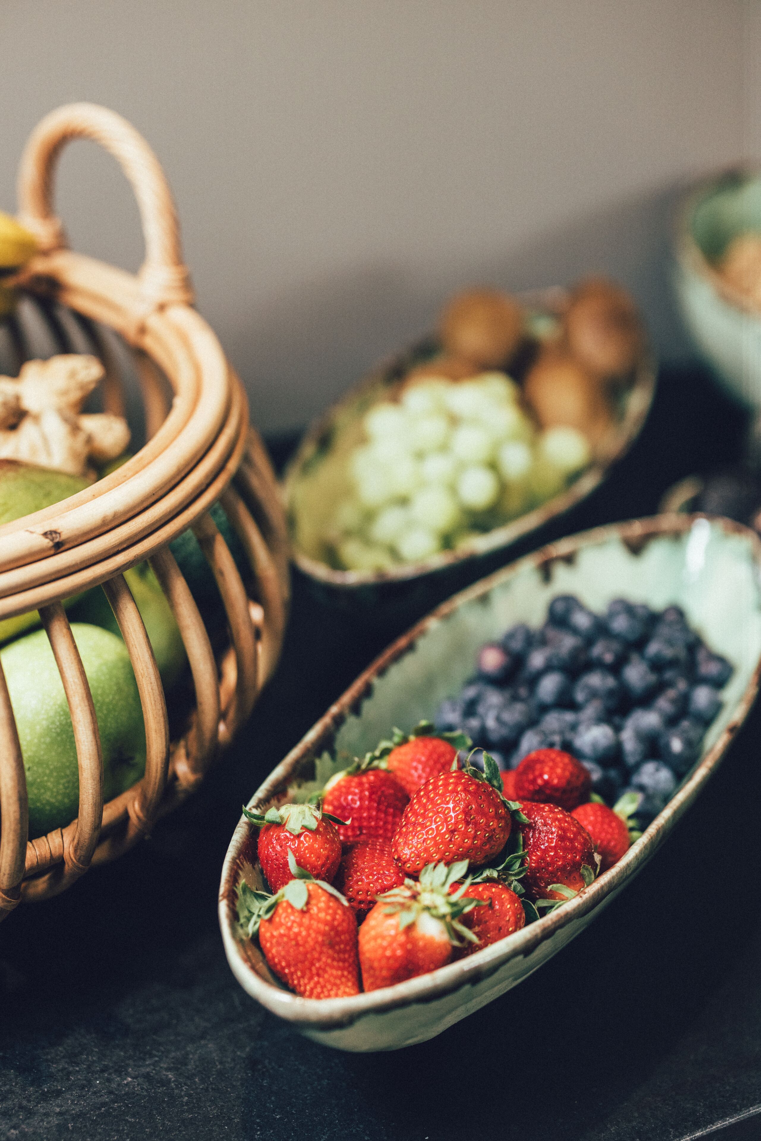 A close-up of a fruit bowl containing strawberries and blueberries.
