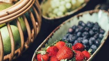 A close-up of a fruit bowl containing strawberries and blueberries.