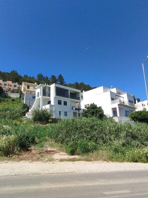 A modern building with a balcony, surrounded by greenery and a clear sky. - Holiday Apartment 'Casa Vale do Paraíso' with Sea View, Private Balcony & Wi-Fi (Sesimbra)