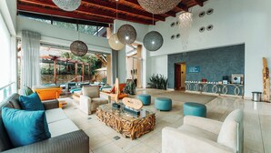 A spacious lobby with a pool area, seating arrangements, and a reception desk. - Silverstar Hotel  (Krugersdorp)