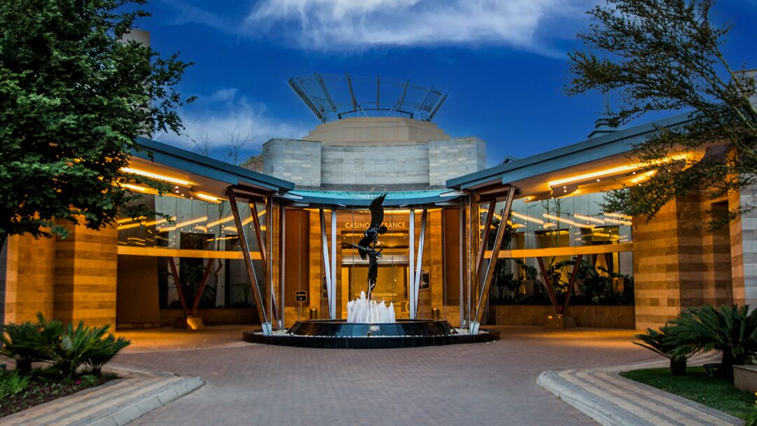 A modern building with a central fountain, large glass windows, and a sign reading "CASINO FRANCE".
