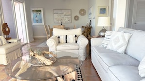 A modern living room with a glass coffee table, white sofas, and a patterned rug. - Villa Morning Glory - Private Pool - Amazing Views (St Thomas)