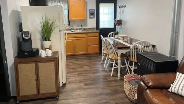 A compact living space with a kitchenette, dining area, and a seating area with a sofa and chairs. - Main St., Sturgis Rally Rental!! Enough Said!! (Sturgis)