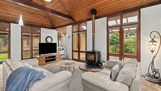 A cozy living room with a fireplace, a television, and comfortable seating.