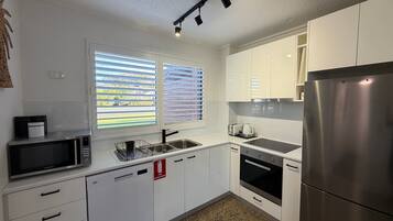 Microwave, oven, dishwasher, dining tables