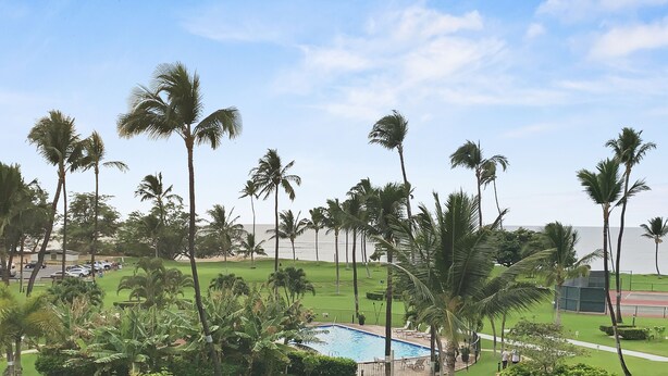 A pool surrounded by palm trees and a well-maintained lawn. - Palms, Pool, and Pacific Ocean views from A414 (Kihei)