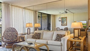 A modern living room with a sofa, two lamps, a coffee table, and a chair. - Palms, Pool, and Pacific Ocean views from A414 (Kihei)