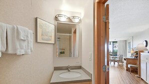 A bathroom with a sink, mirror, and towels. - Maui Sunset A415: 1  BR, 2  BA Condominium in Kihei, Sleeps 5 (Kihei)
