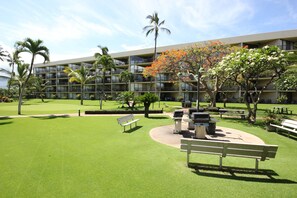 Relax in a serene outdoor space surrounded by lush trees and beautifully manicured lawns.