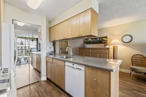 Enjoy cooking and entertaining in this well-lit kitchen with a dishwasher and ample counter space.