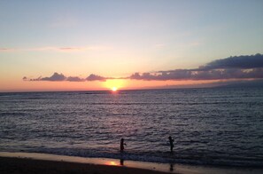 Enjoy a serene beach experience with gentle waves lapping at the shore.