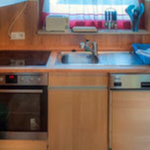 Kitchen features an oven, dishwasher, and stainless steel sink.