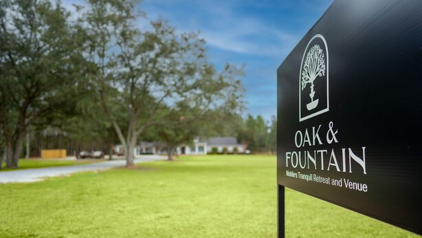A sign for Oak & Fountain, a mobile tranquil retreat and venue. - 1 Bedroom Apartment at Oak + Fountain - #5 (Grand Bay)