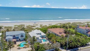 A coastal residential area with houses, a swimming pool, and a beach view. - Sea Watch: 4B/4B Direct Oceanfront Home with Pool Near Downtown Cocoa Beach (Cocoa Beach)