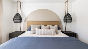 A bedroom with a bed, two nightstands, and two hanging lamps. - Spacious 2 Bedroom East Riverside Home with Garage and Yard (Austin)