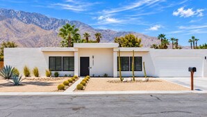 A modern two-story house with a garage, surrounded by desert vegetation and mountains. - Azul Desert Escape with Pool & Views (Palm Springs)