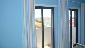 A balcony with a view of a marina and distant landscape. - Seaview Townhouse by the riverside in the centre of Alvor (with terrace) (Alvor)