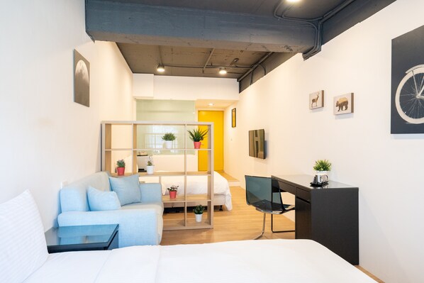 Deluxe Quadruple Room | Desk, laptop workspace, blackout drapes, iron/ironing board