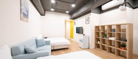 Deluxe Quadruple Room | Desk, laptop workspace, blackout drapes, iron/ironing board