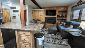A modern kitchen with granite countertops, wooden cabinetry, and a built-in dishwasher. - Clean, Cozy & Completely Updated! 1B 1B Condo w Jetted Tub Room! (Wakefield)