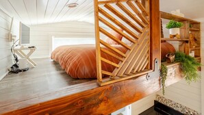A bedroom with a wooden ladder bed, a small desk, and a shelf with plants. - Tiny home 🏡 Northgate- 15min to downtown (Seattle)