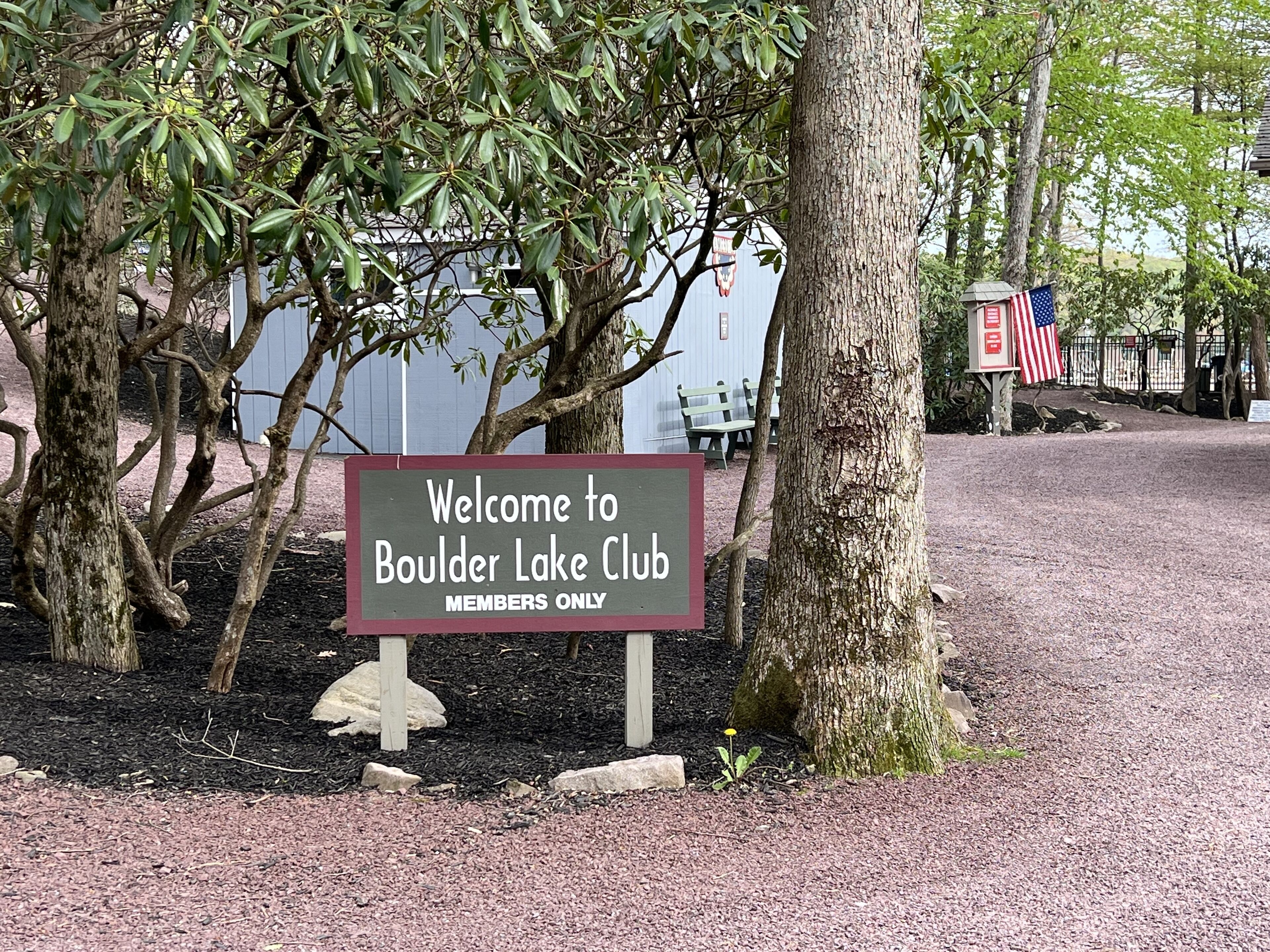A sign welcoming visitors to Boulder Lake Club with a 'Members Only' notice.